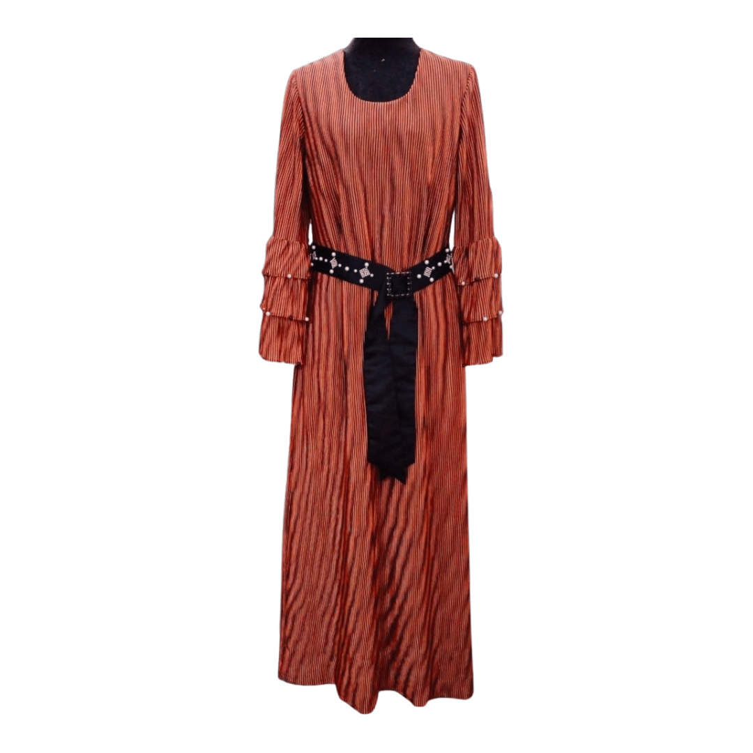 Long rust-colored dress with a black belt on a white background