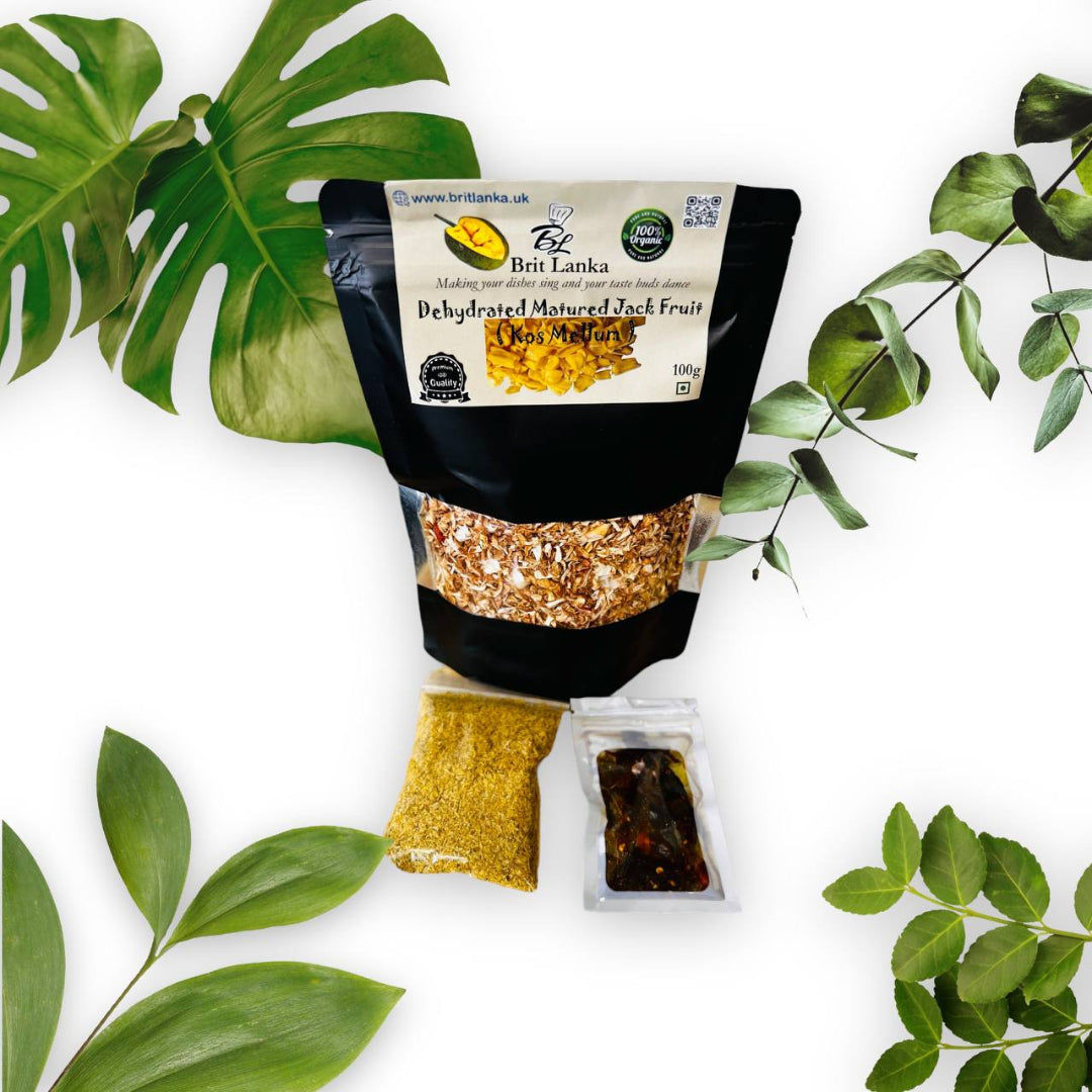 Packaging of dehydrated matured jack fruit with a transparent window showing the product inside. The package is placed against a backdrop with leafy elements.