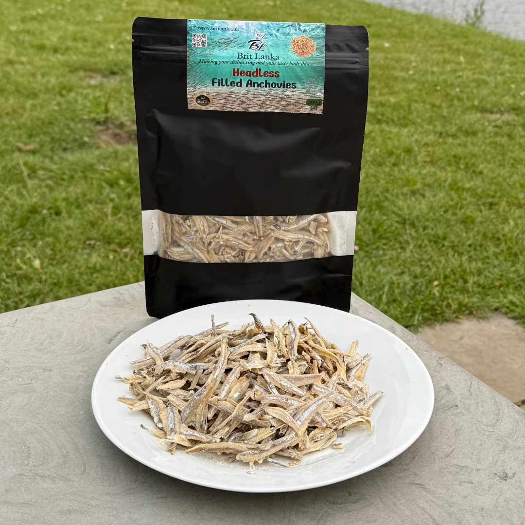 Packaged headless filled anchovies with a plate of anchovies on a grassy background