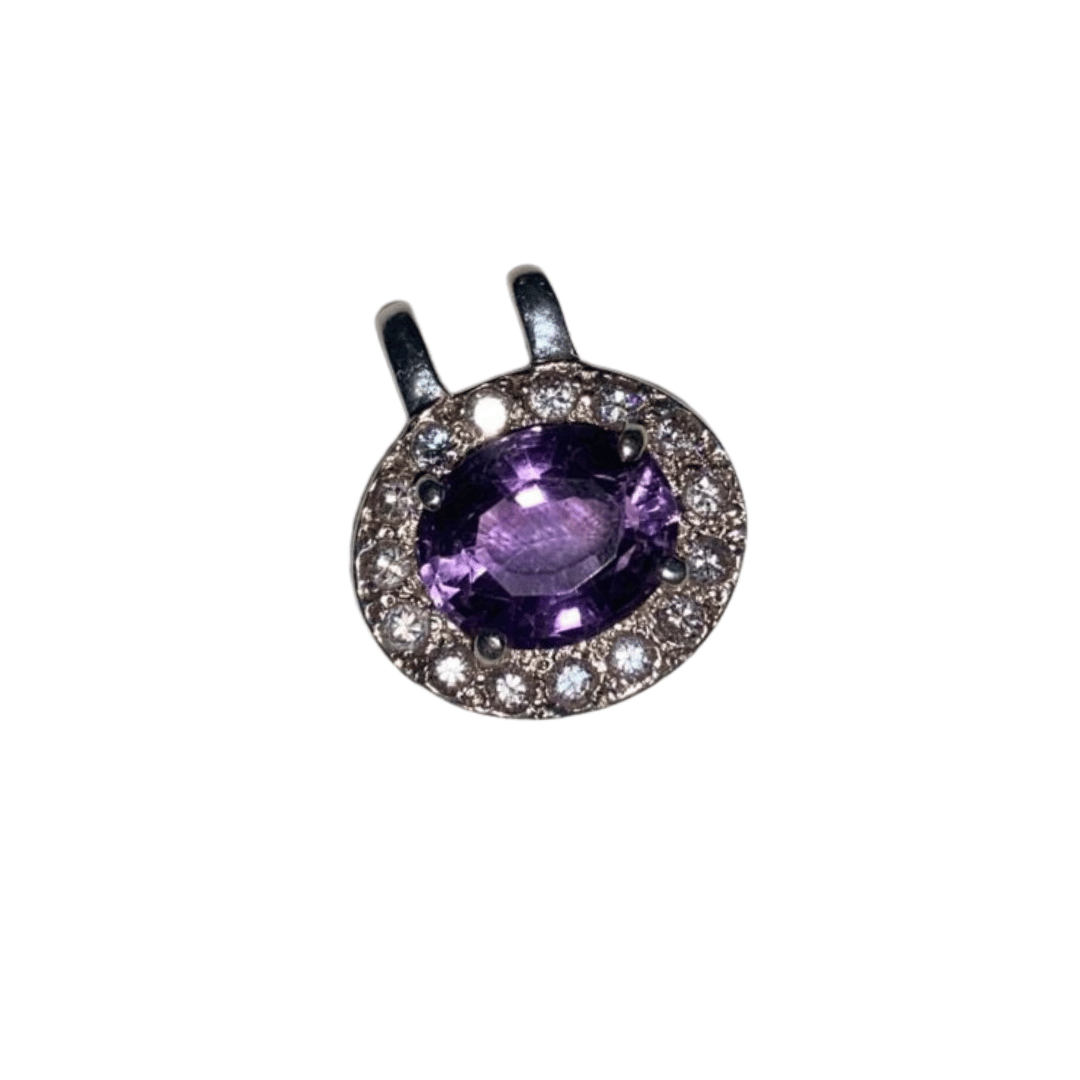 Jewelry pendant with purple gemstone and diamond accents on a white background