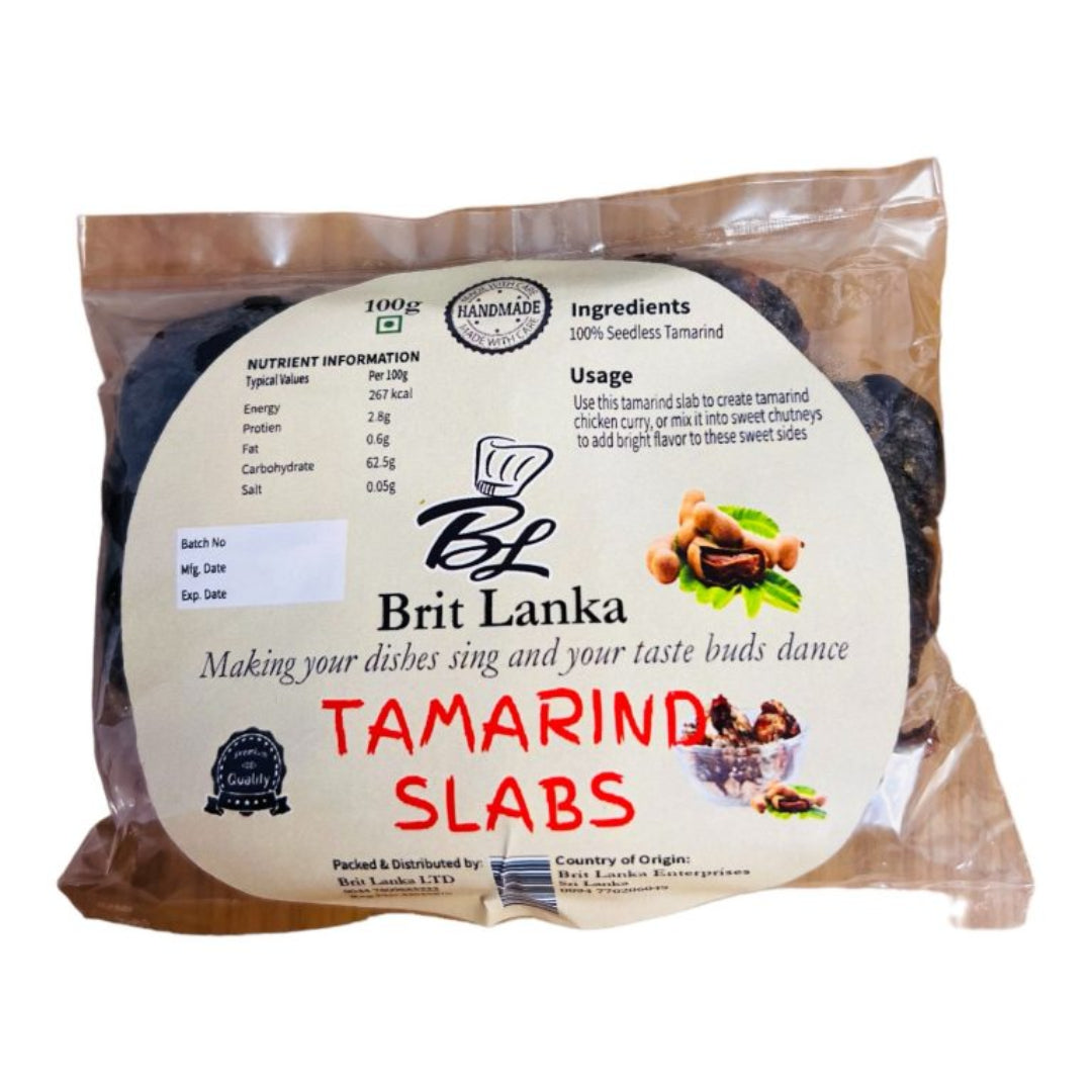 Packaged tamarind slabs in a transparent plastic wrapping with branding and product information labels.