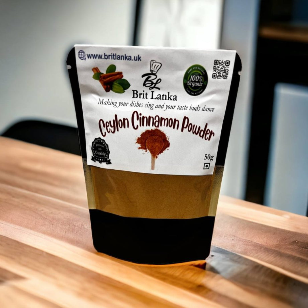 A package of Ceylon Cinnamon Powder by Brit Lanka spices, showing the product name and branding, placed on a wooden surface.