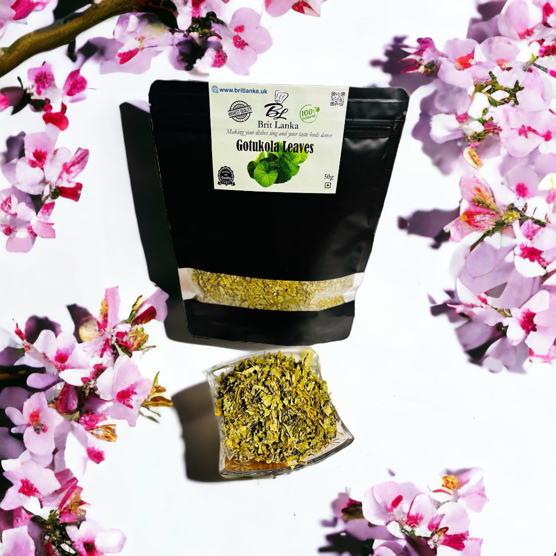 Packaging of dehydrated GOTU KOLA leaves with a clear window showing the product inside, placed against a floral background.