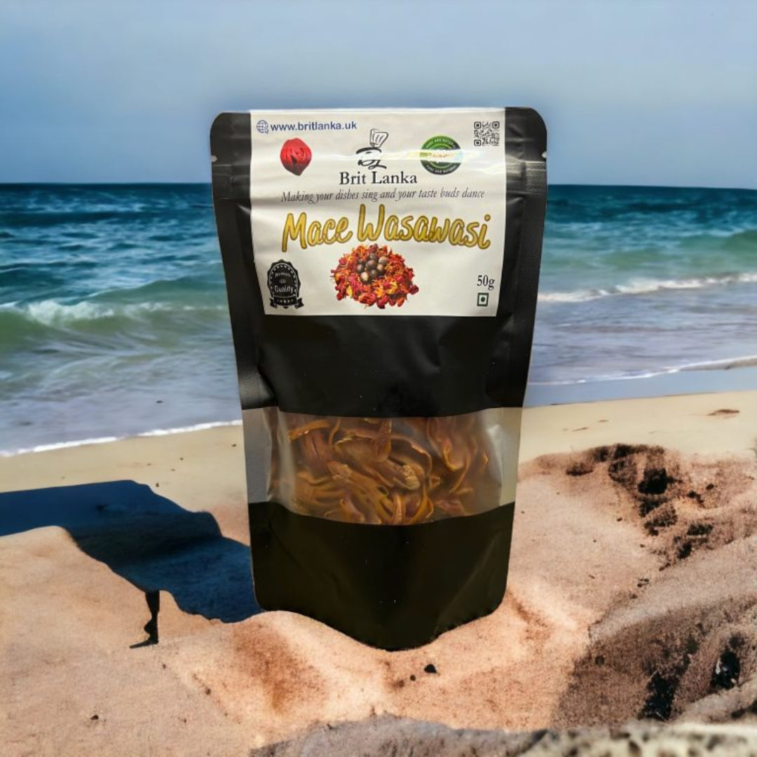 Packaging of Ceylon Nutmeg Mace Blades placed on a beach with the ocean in the background, indicating organic and natural qualities.